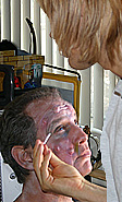 markus applying makeup boils to face of Steven Mandel